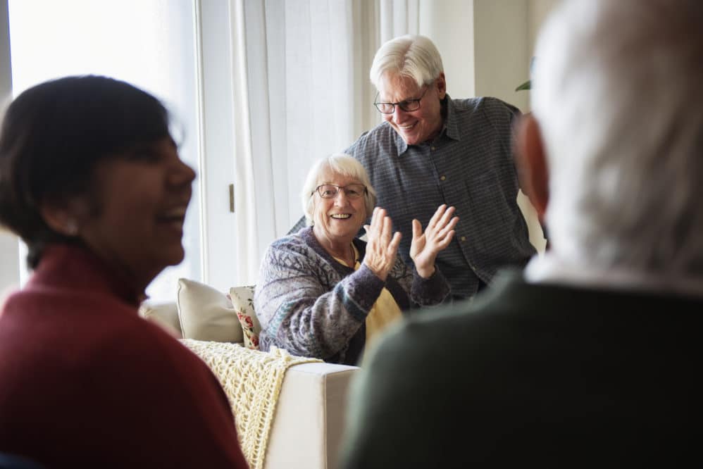 Senior people talking in a living room - Assisted living
